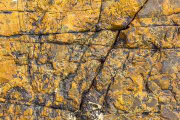 gray yellow brown stone surface with deep relief. natural texture