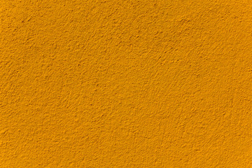 yellow concrete wall closeup. rough surface texture