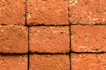 red stone wall of porous volcanic bricks. rough surface texture