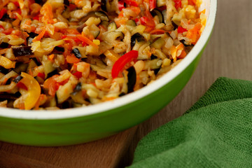 Vegetable stew in a pan. Steamed vegetables closeup. Cooking dishes of eggplant, onion, pepper, zucchini, pomdor, carrots for a healthy diet. Vegetable stew on the table.