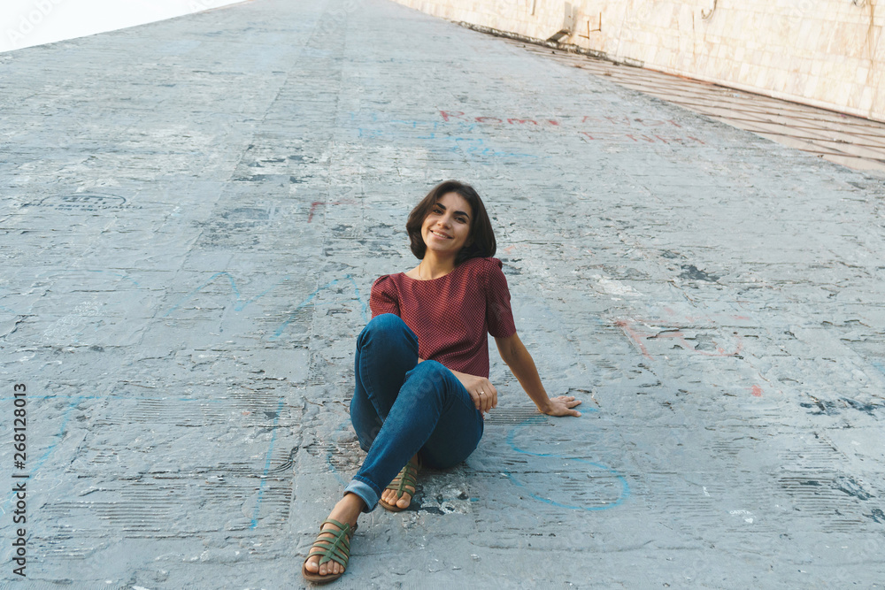 Sticker smiling woman on cement building