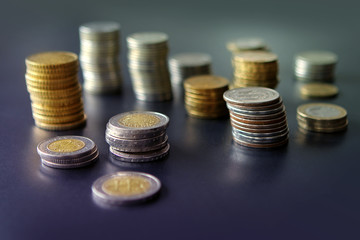 Closeup of silver and copper coins of all states on a dark background
