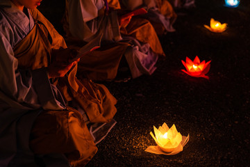 Monks praying at night on Vesak day for celebrating Buddha's birthday in Eastern culture