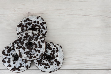 Donuts on a white wood background. Top view, copy space