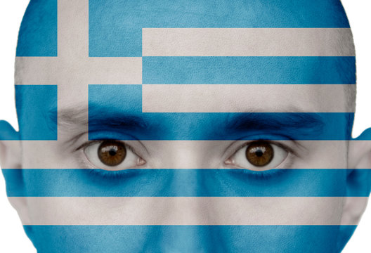 National flag Greece colored depicted in paint on a man's face close-up, isolated on a white background