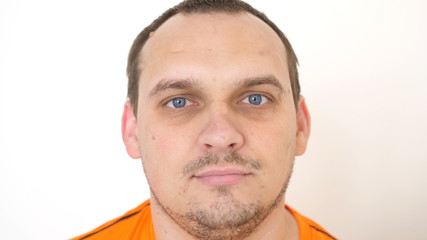 Fototapeta premium Face of young attractive bearded man with blue eyes on a white background