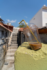 abandoned old plastic drinking cup with coffee