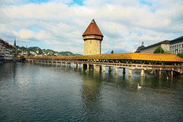 Famous Chapel bridge (The Kapellbrücke) in Lucerne in a beautiful summer cloudy day in Switzerland 