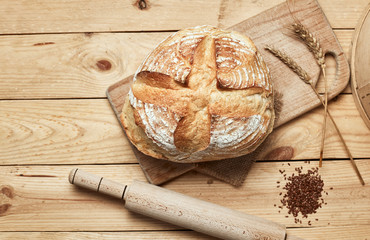 Obraz na płótnie Canvas Freshly baked bread on wooden background. Bread at leaven. Unleavened bread.