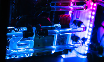 Inside a high performance computer. Computer circuit board and CPU cooling fans illuminated by internal LEDs inside a server class computer.