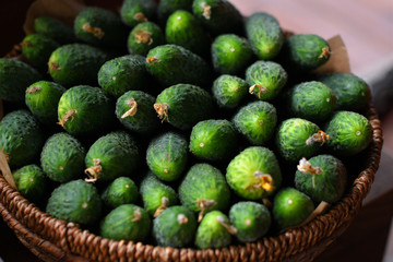 fresh green crisp cucumbers in a wooden basket. The spring avitaminosis