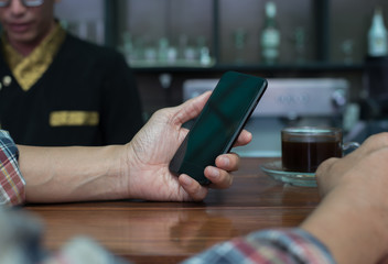 Man using smartphone at coffee shop