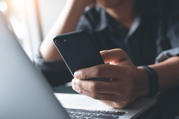 Man using mobile phone and laptop