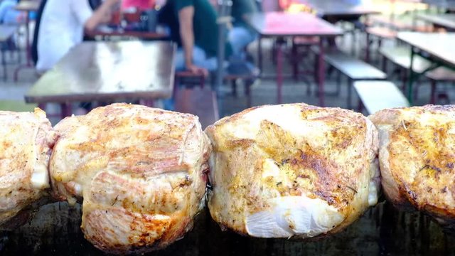 Delicious crunchy chicken is grilling on skewers above fire