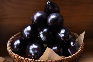 fresh eggplants in a wooden basket. The spring avitaminosis