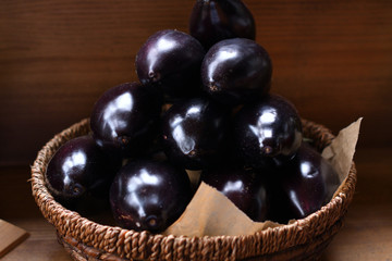fresh eggplants in a wooden basket. The spring avitaminosis