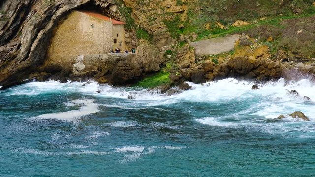 Chapel Santa Justa and stormy ocean, Spain