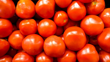 Closeup photo of lots of fresh ripe tomatoes.Texture or pattern of fresh ripe vegetables