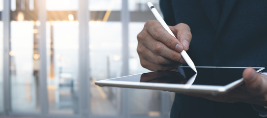 Businessman using digital tablet with stylus