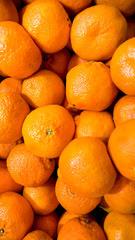 Closeup image of beautiful oranges lying on sotre counter. Closeup texture or pattern of fresh ripe fruits. Beautiful food background