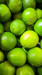 Closeup shot of green limes. Closeup texture or pattern of fresh ripe fruits. Beautiful food background