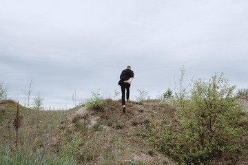 Portrait of a guy running through the mountains in search. Nutrition of confusion, feelings, despair, haste