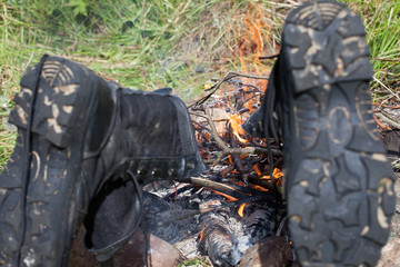 the got wet tourist boots dry at a fire