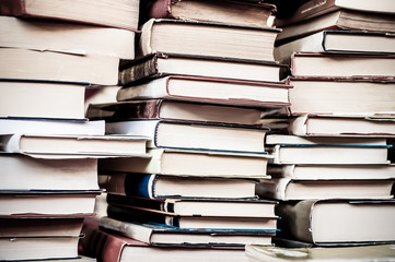 Books background. Piles of old used books.