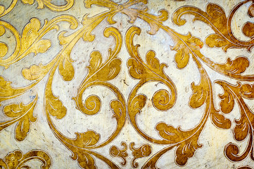 Gold flourish design. White background.