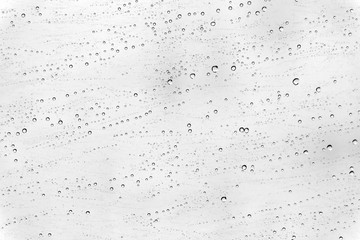 In selective focus many droplets on car mirror on white background 