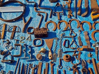 Lot of iron tolls and horseshoes at a flea market