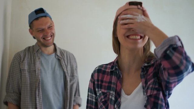 Husband and wife, newlyweds make repairs in their apartment. New building, apartment design. Funny video, happy couple in love
