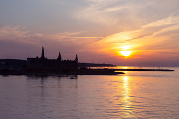 Kronborg castle silhouette in Helsingor at sunset, Denmark. Castle on the shore in Helsingor. Danish harbour of Helsingor with Kronborg castle. Panoramic view to Kronborg castle, Helsingor, Denmark.