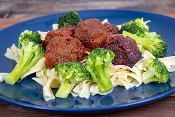 sweet and spicy meat balls meal over pasta