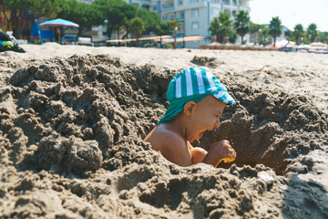 screaming boy in sand