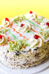 Traditional sweet birthday cake with colorful candles.