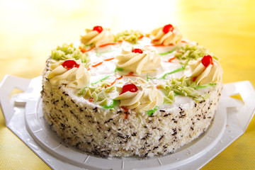 Traditional sweet birthday cake with colorful candles.