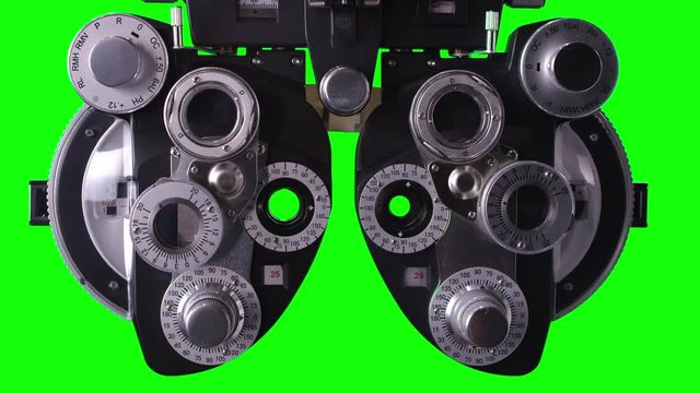 Close up view of Phoropter for Optometrist on green screen to use for editing and keying out green.