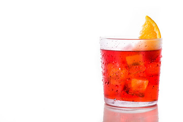 Negroni cocktail with piece of orange in glass isolated on white background. Copyspace