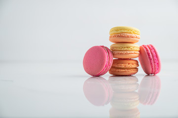 A french sweet delicacy, macaroons variety closeup.macaroon colourful,Different types of macaroons on a white wooden background