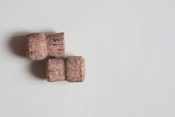 Two wine cork stoppers on beige background. Top view.