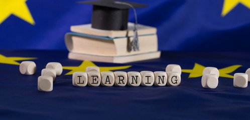 Word  LEARNING  composed of wooden letters.
