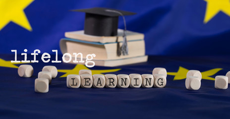 Words LIFELONG  LEARNING  composed of wooden letters.