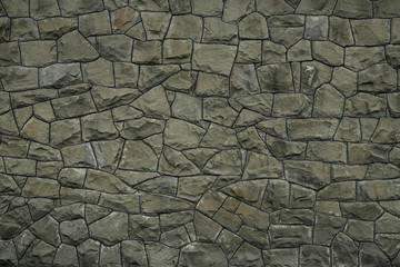 Gray green stone wall texture background. Rock texture. Green granite stone surface. Mosaic pattern...