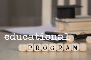 Words  EDUCATIONAL PROGRAM composed of wooden dices.