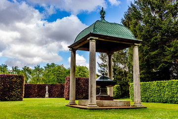 pavilion with green fountain in old park