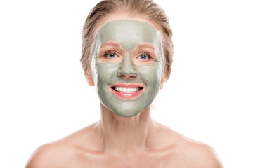 smiling mature woman with clay mask looking at camera Isolated On White