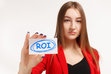 Business, technology, internet and networking concept. Young entrepreneur showing keyword: ROI