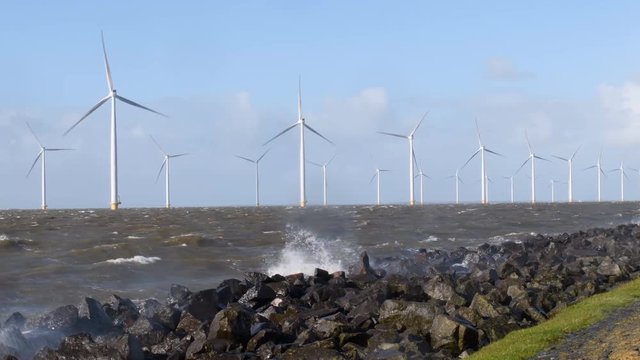 Windturbines in a winter storm at the IJsselmeer in The Netherlands.