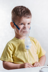 small child treats bronchitis inhaler at home